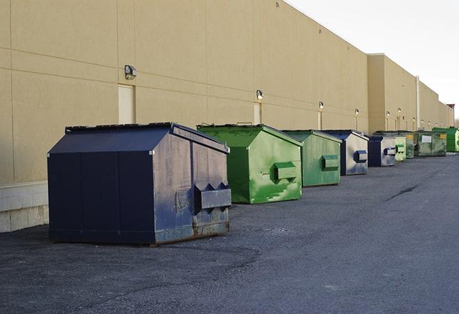 a group of dumpsters lined up along the street ready for use in a large-scale construction project in Alamo, TX